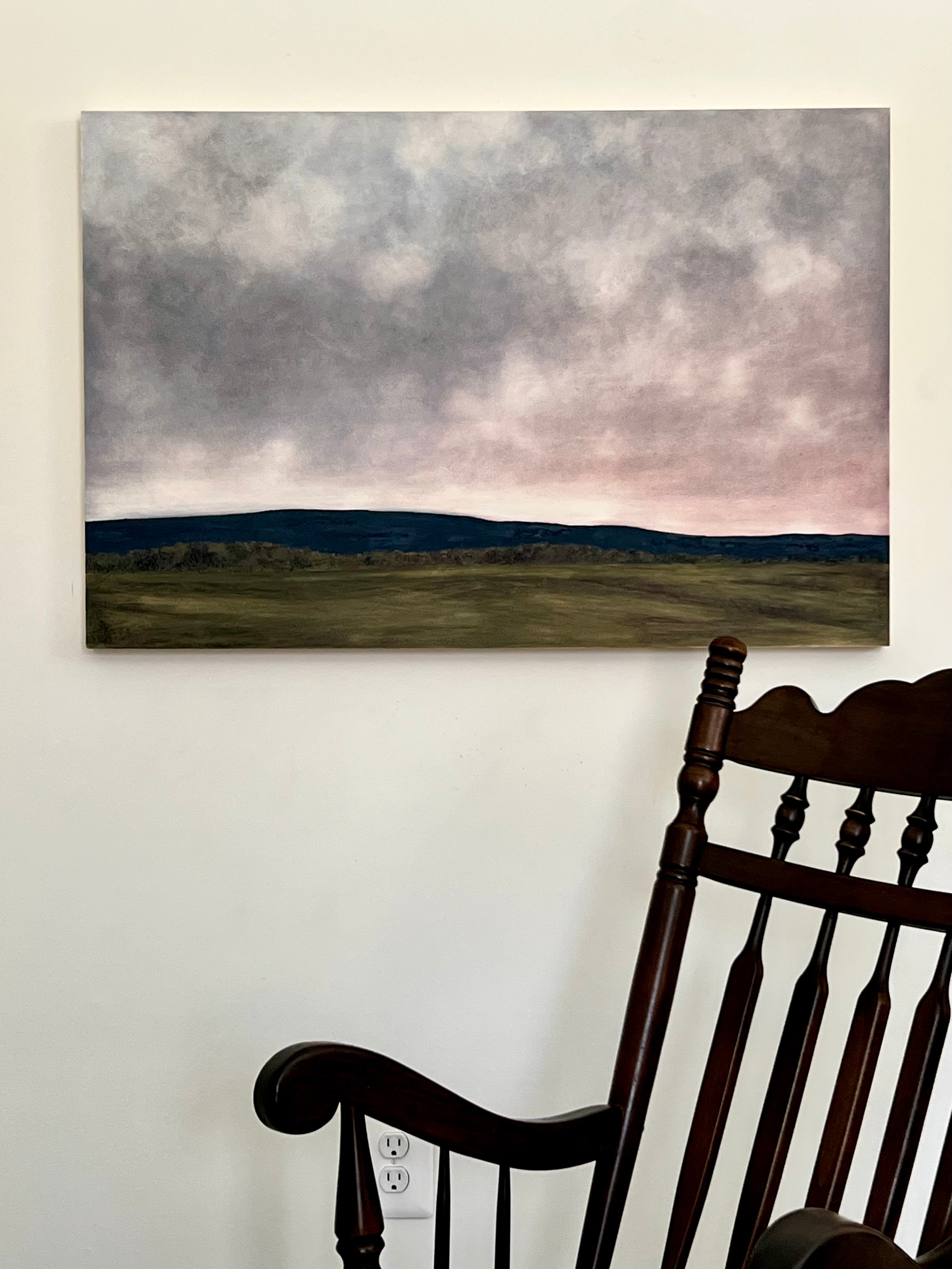 Painting of a landscape with mountains and clouds.